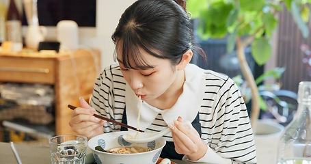 Image showing Restaurant, food and Japanese woman with noodles for eating meal, lunch and dinner in cafe. Ramen, cafeteria supper and person with chopsticks for traditional cuisine for health, wellness and hunger