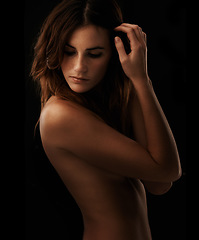Image showing Woman, body and skincare in studio for cosmetics, dermatology and shadow for art deco and aesthetic. Beauty model or serious person thinking of self care and glow isolated on dark or black background