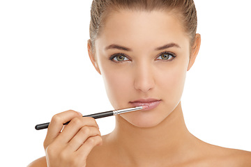 Image showing Makeup, brush and portrait of woman with lipstick application in studio for cosmetics on white background. Beauty, mouth or face of female model with gloss, color or full lips, volume or filler