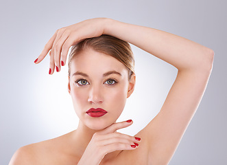 Image showing Woman, portrait and serious in studio with red lipstick for cosmetics, beauty and aesthetic with nail polish. Model, person and confidence with skincare, glowing face and wellness on white background