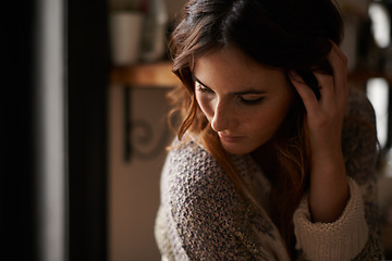 Image showing Lonely, depression and young woman at a home with upset, grief and mad facial expression for problem. Mental health, emotion and sad female person looking down with unhappy face for loss at house.