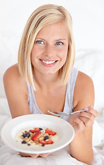 Image showing Happy woman, portrait and breakfast in bed with muesli, meal or berries for balance, wellness or gut health at home. Fruit, eating or lady person face in bedroom for diet, nutrition or superfoods