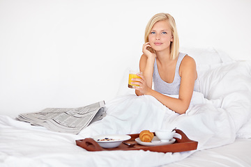 Image showing Healthy, breakfast and portrait of woman in bed with food, orange juice and relax with newspaper. Calm, girl and eating in bedroom on vacation with croissant, brunch and glass with drink in home