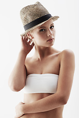 Image showing Young model, portrait and straw hat in studio, confident and trendy summer accessory by white background. Blonde woman, face or pride for healthy body in funky clothes, feminine or slender in bikini