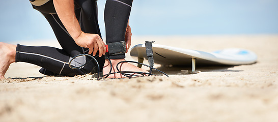 Image showing Legs, strap for safety and surfer on beach for sports, fitness and training on travel vacation in summer. Hands, ankle and surfboard with person on sand by ocean or sea for surfing hobby or holiday