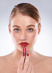 Image showing Woman, portrait and beauty in studio with red lipstick for cosmetics, makeup and aesthetic with manicure. Model, person and confidence with lips application, glowing face and skin on white background