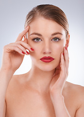Image showing Woman, portrait and makeup in studio with manicure for cosmetics, beauty or aesthetic with red lipstick. Model, person and confidence with skincare, glowing face and skin wellness on white background