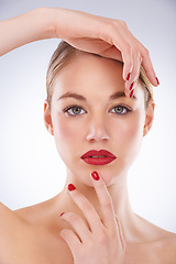 Image showing Woman, portrait and makeup in studio with manicure for cosmetics, beauty and aesthetic with red lipstick. Model, person or confidence with skincare, glowing face and skin wellness on white background