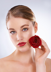 Image showing Portrait, rose and woman with skincare, dermatology and beauty on a white studio background. Face, person and model with flowers and grooming with natural cosmetics and treatment with shine and glow