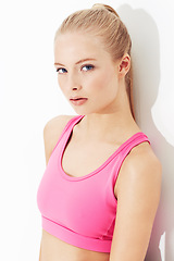 Image showing Portrait, fitness and serious young woman in studio isolated on a white background. Face, healthy body and person exercise, blonde model training or sportswear for physical workout in Switzerland