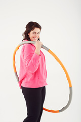 Image showing Happy woman, portrait and hoop for fitness, exercise or workout in balance on a white studio background. Active female person smile with plastic circle for training, practice or health and wellness