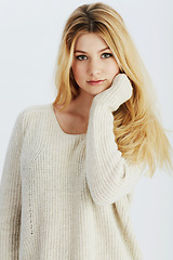 Image showing Portrait, winter fashion and sweater with woman in studio on white background for comfortable style. Model, clothes and outfit with confident young person in warm clothing for cold weather season