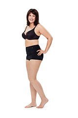 Image showing Portrait, happy and plus size woman in underwear in studio isolated on a white background mockup space. Smile of person, model and body positivity, self acceptance and confidence in natural beauty