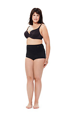Image showing Portrait, confidence and plus size woman in underwear in studio isolated on a white background mockup space. Person, model and body positivity, self acceptance or natural beauty of healthy young girl