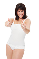 Image showing Portrait, thumbs up and plus size woman in underwear in studio isolated on a white background. Smile, body positive model and like hand gesture for success, winning or agreement symbol of happy girl