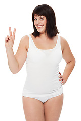 Image showing Portrait, peace sign and plus size woman in studio isolated on a white background. V hand gesture, smile or model in underwear for beauty in body positivity with emoji for victory, success or winning