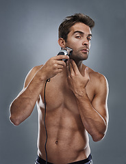 Image showing Man, portrait and electric razor in studio for beard maintenance, hair removal or grey background. Male person, shirtless and tools for cleaning skin or hygiene car for confidence, health or mockup
