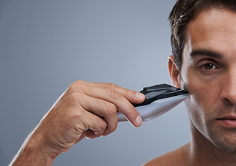 Image showing Man, electric razor and closeup studio portrait for grooming, skincare or wellness by grey background. Person, model and shaving beard with hygiene, facial hair removal or product for cosmetic change