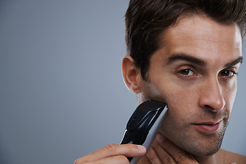 Image showing Man, portrait and electric razor for shaving beard or maintenance, hair removal or grey background. Male person, shirtless and tools for cleaning skin or hygiene car for confidence, studio or mockup