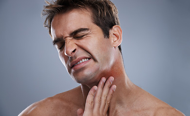 Image showing Man, neck and red rash pain from razor burn for hair removal for hygiene maintenance, mistake or grey background. Male person, hand and unhappy in studio or care fail in inflammation, itchy or mockup