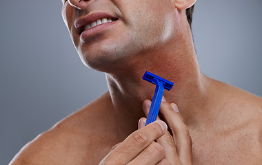Image showing Person, shaving and beard or razor burn for hair removal or red rash, inflammation or grey background. Hand, tool and hygiene mistake in studio or accident for wellness maintenance, pain or mockup