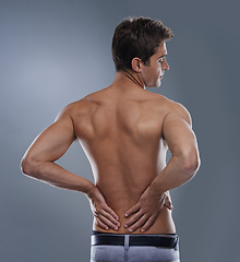 Image showing Back pain, injury crisis and studio man with medical emergency, sore spine or osteoporosis. Backache, anatomy and person massage joint ache, accident or hurt muscle strain on grey background