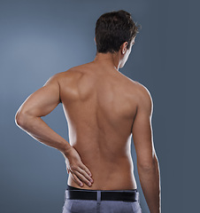 Image showing Back pain, injury crisis and studio person with medical emergency, sore spine or osteoporosis. Backache, arthritis and model massage joint ache, accident or hurt muscle strain on grey background