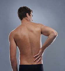 Image showing Injury, crisis and studio man with back pain emergency, sore spine or chiropractic backache. Osteoporosis, orthopedic problem and person with body ache, accident or muscle risk on grey background