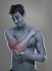 Image showing Joint pain, arm injury and man with elbow problem, medical emergency and massage tendinitis. Red glow, osteoporosis and studio person with inflammation, accident or hurt anatomy on grey background