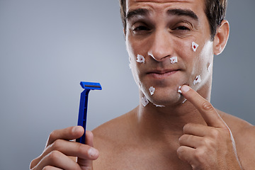 Image showing Man, face and shave cuts or pain for hair removal or hygiene injury with blood, tissue or maintenance. Male person, grey background and dermatology with beard or clean health, studio or mockup space