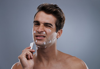 Image showing Man, face and shave cuts or hygiene for hair removal or injury with blood, tissue or maintenance. Male person, grey background and dermatology with beard or clean health, wellness or mockup space