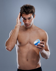 Image showing Studio, portrait and man with gel for hair care, cream and shine for styling or salon product. Model, face or happy for conditioner for male beauty or keratin treatment for growth by gray background