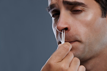 Image showing Man, nose and hair with tweezers for cleaning on grey background for self care, wellness or hygiene. Male person, face and grooming for cosmetic beauty for healthy routine, studio or mockup space