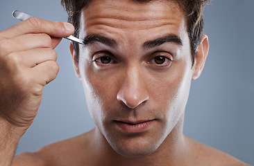 Image showing Man, portrait and tweezers for eyebrows or wellness for face grooming, hygiene or grey background. Male person, tools and hair removal for healthy morning routine or studio, treatment or mockup space