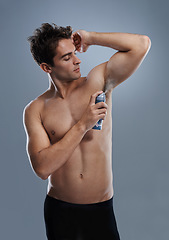 Image showing Man, deodorant and cleaning armpit for smell in studio or product application for odor, hygiene or grey background. Male person, topless and confidence or health wellness, self care or mockup space