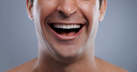 Image showing Man, mouth and laughing with face and lips with hygiene, jawline and satisfaction with treatment closeup. Grooming, confidence and skincare with male model in studio background for cosmetics