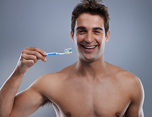 Image showing Portrait, man and smile with toothbrush, dental hygiene and body care on grey studio background. Face, person and model with fresh breath and healthy with toothpaste and morning routine with wellness