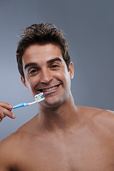 Image showing Portrait, toothbrush and man with a smile, clean and morning routine on grey studio background. Happy, person or model with dental hygiene or oral health with fresh breath or toothpaste with wellness