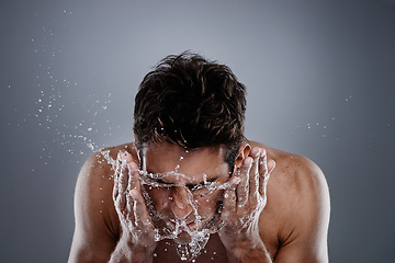 Image showing Water splash, studio and man wash face for self care routine, morning facial cleanse or skincare. Liquid, wellness and person with hygiene treatment, grooming and skin cleaning on grey background