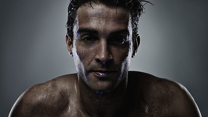 Image showing Portrait, man and water with skincare, sweating and dermatology on a grey studio background. Face, person and purple liquid with hydration and beauty with morning routine, wet and luminescent with uv