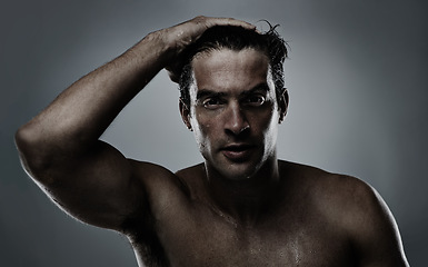 Image showing Portrait, man and water with dermatology, sweating and morning routine on a grey studio background. Face, person and grooming with hydration and beauty with model, wet and cosmetics with skincare