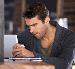 Image showing Tablet, research and young man in cafe working on freelance creative project on the internet. Digital technology, reading and male designer freelancer on website for information in coffee shop.