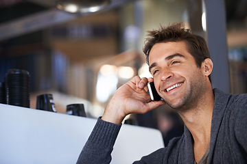 Image showing Phone call, happy and young man networking for deal, good news or work communication in cafe. Smile, satisfaction and male person on mobile conversation with cellphone for career in coffee shop.