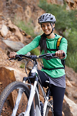 Image showing Woman, mountain bike and portrait with smile, adventure and helmet for safety, fitness and health. Girl, bicycle and happy for training, race or challenge by hill, countryside or outdoor in Argentina