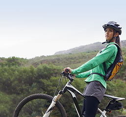Image showing Woman, mountain bike and thinking in nature, fitness and helmet for safety, adventure and mock up space. Girl, bicycle and happy for training, race and outdoor challenge in countryside in Cape Town