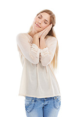 Image showing Woman, sleep and hand gesture with eyes closed in studio isolated on a white background. Tired model, dream and pretend to nap, resting for health and calm to relax in peace for energy in the morning