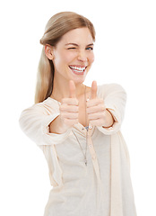 Image showing Portrait, wink and happy woman with thumbs up in studio for support, trust or winning gesture on white background. Face, smile and female model with hand emoji for success, thank you or motivation
