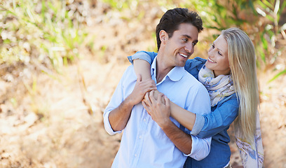 Image showing Happy couple, hug and nature for love, support or affection in outdoor walk or bonding. Young woman and man smile in natural care or trust for embrace, comfort or romance in forest or woods together