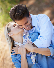 Image showing Happy couple, kiss and hug in nature for affection, love or support in outdoor walk or bonding. Young woman kissing man on cheek with smile for embrace, comfort or romance in forest or woods together