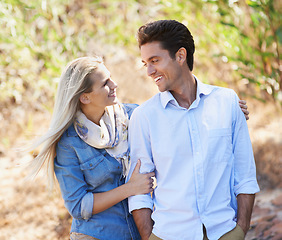 Image showing Happy couple, walking and hug in nature for bonding, love or support in relax for outdoor affection. Face of young woman and man with smile for embrace, comfort or romance in forest or woods together